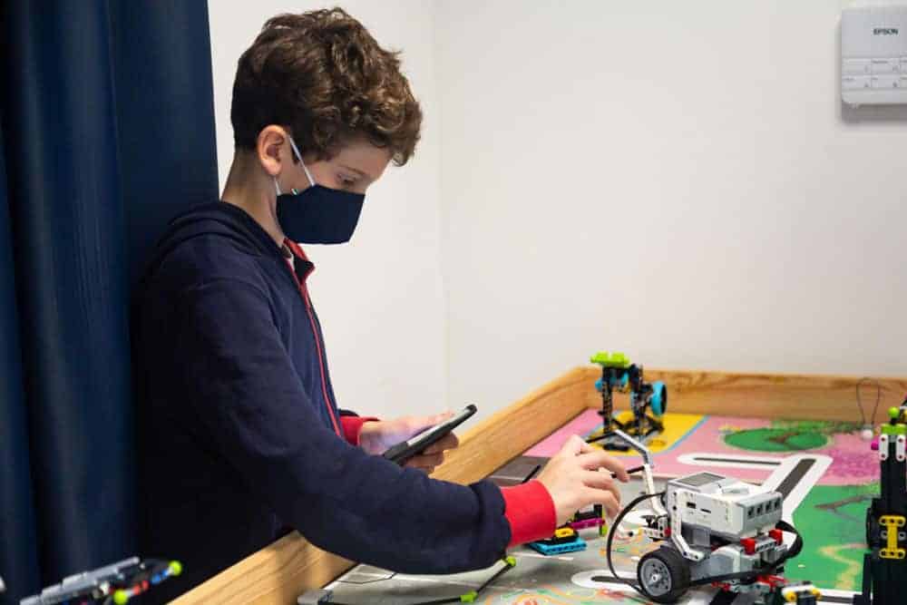 Engaging student working on robotics projects at an international school for optimal learning opportunities.