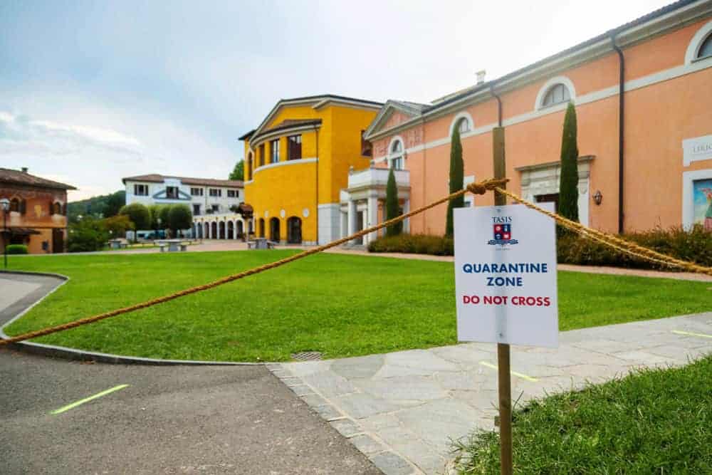 This Month at TASIS: September 2020 2 Empty school campus with quarantine zone sign, outdoors, educational environment, COVID-19 safety, school closure precautions.