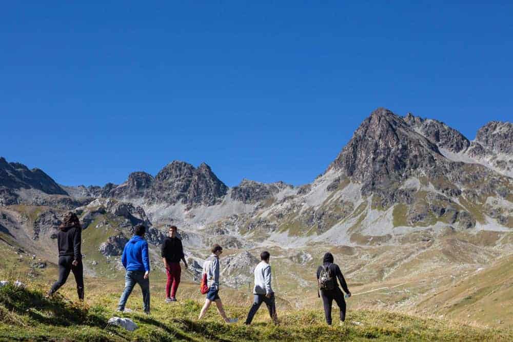 This Month at TASIS: September 2020 4 Adventurous students hiking in the mountains beneath clear blue sky.