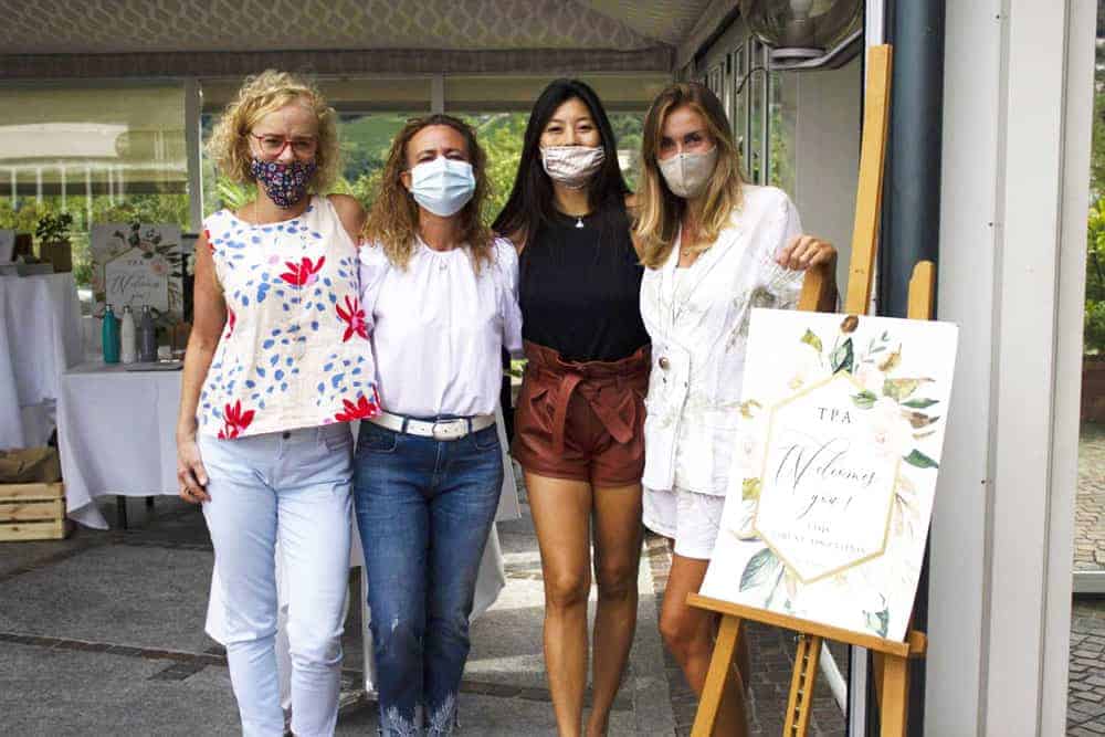 This Month at TASIS: September 2020 6 Happy women wearing masks at an outdoor educational event, showcasing global school community engagement and environment.