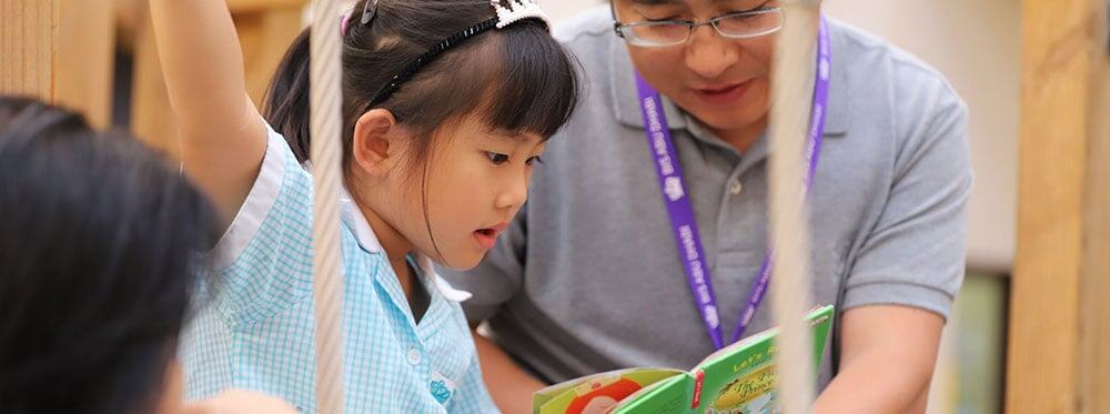Bright young girl learning with teacher in a vibrant classroom, embracing innovative educational methods.