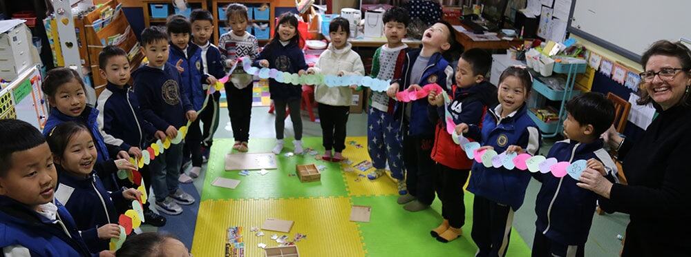 Bright young students engaging in classroom activity at an international school.