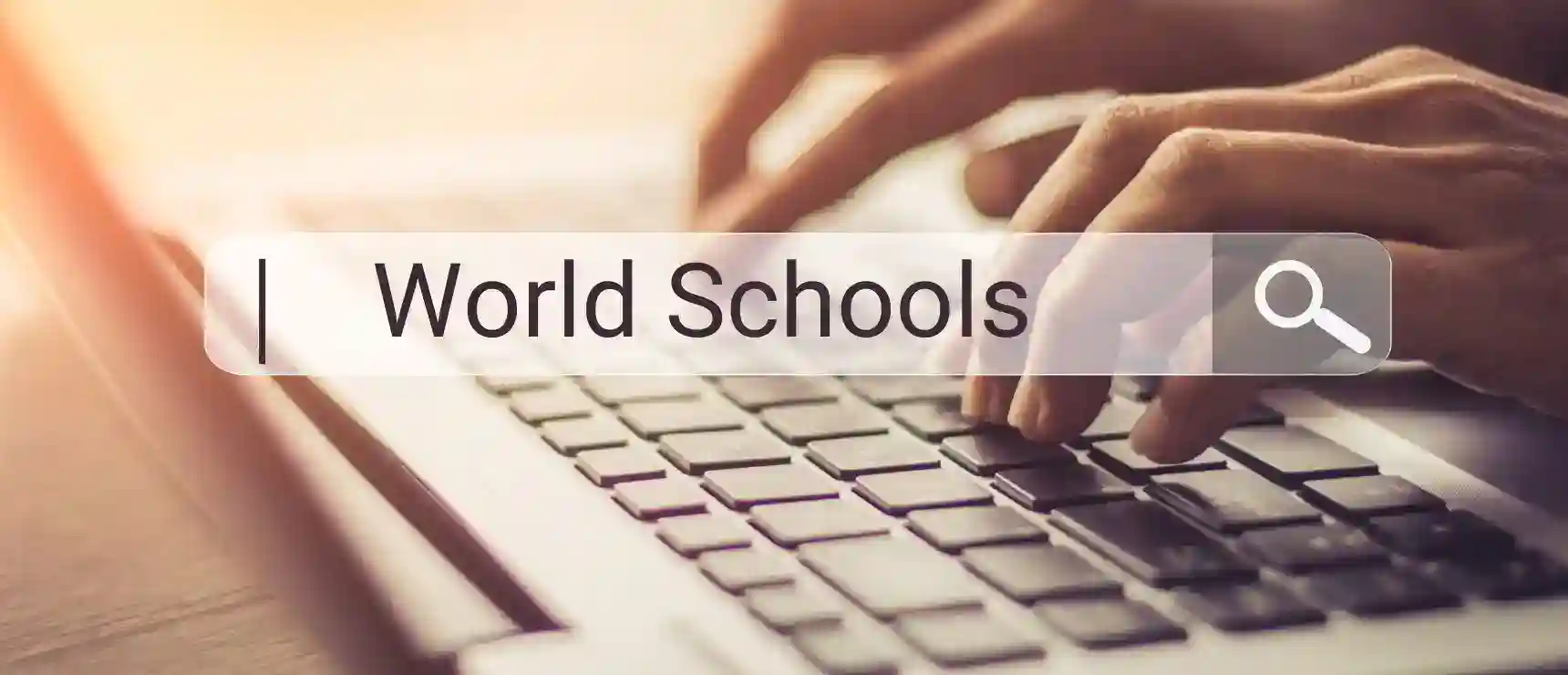 Bright image of hands typing on a laptop keyboard for international education at World Schools.