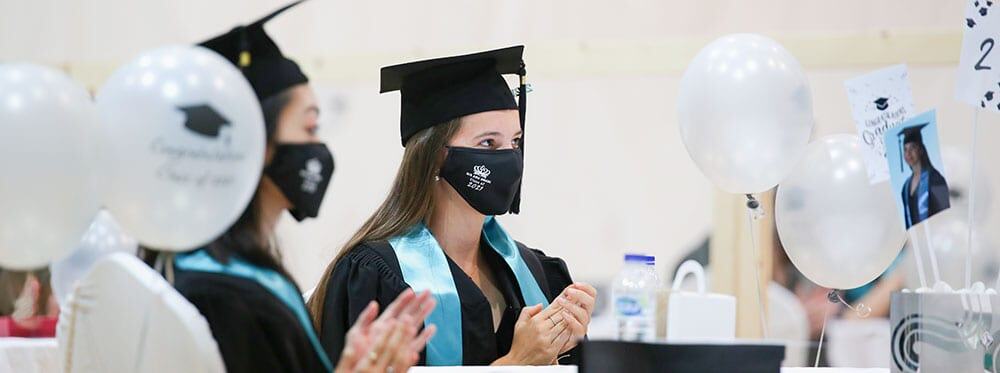 Graduates celebrating achievement at a World Schools graduation ceremony, emphasizing international education excellence.