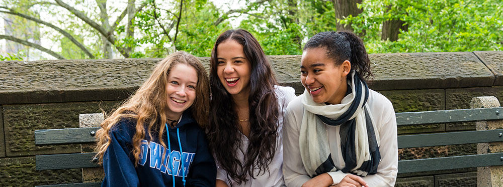 Vibrant diverse students enjoying outdoor learning experience at a world schools campus.