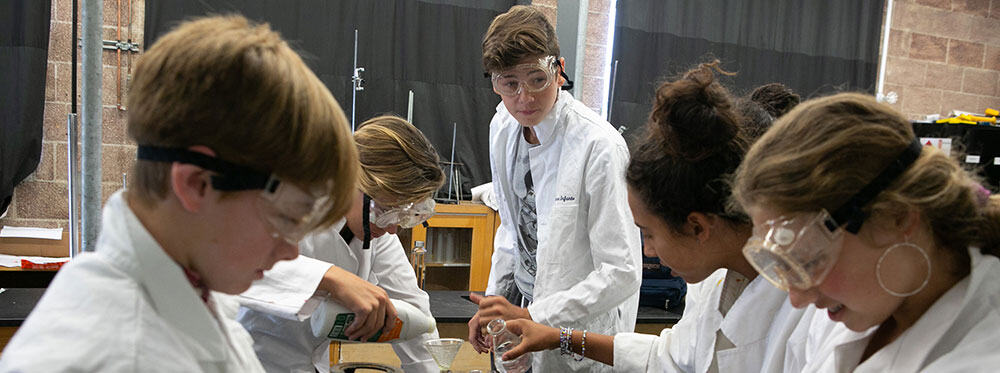 Innovative science students conducting experiments in a modern classroom at a top international school.