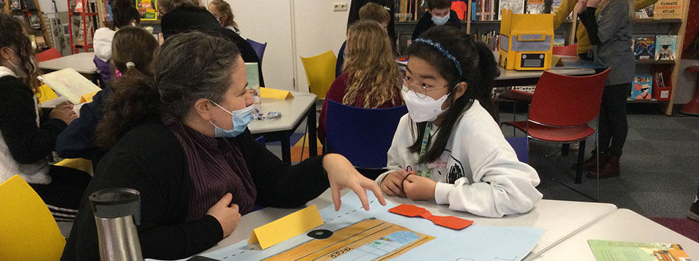 Diverse students engaging in learning activities in a modern classroom environment.