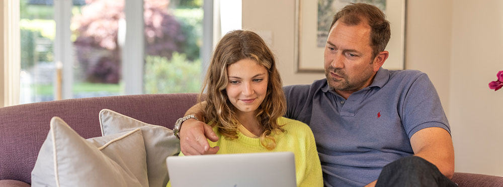 Engaging parent and daughter exploring online learning opportunities at a world school.