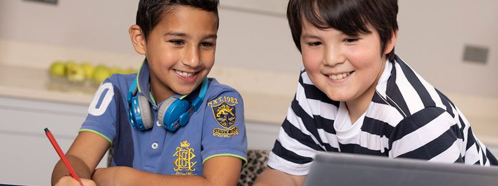 Bright young students studying together in a modern classroom at a top world school.