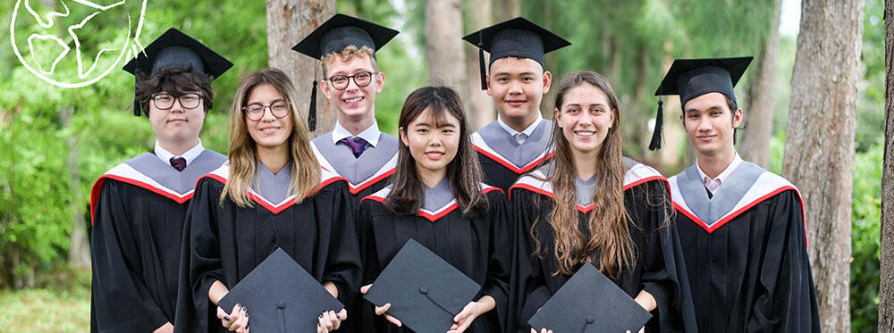 Graduates in caps and gowns celebrating at a world-class international school graduation ceremony.