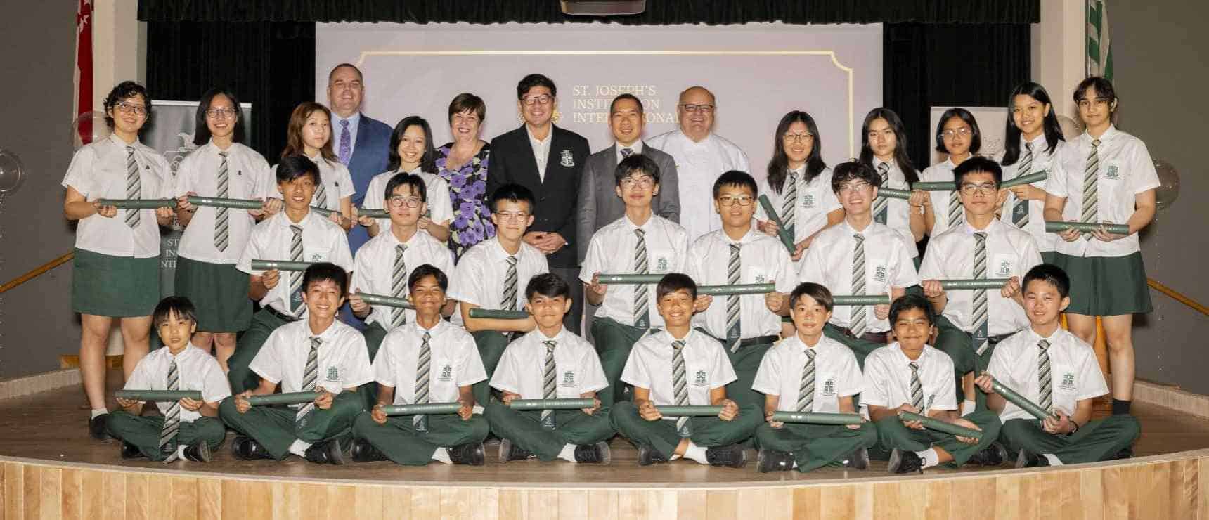 Bright students at world-class school holding diplomas and certificates for academic achievements.