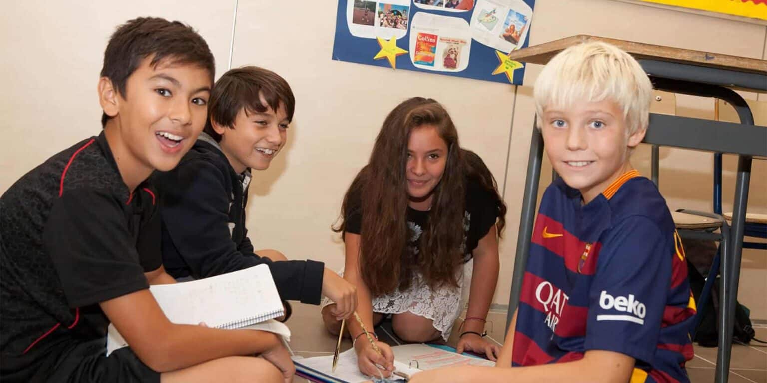 Diverse group of students collaborating in a classroom to enhance educational experience at World Schools.