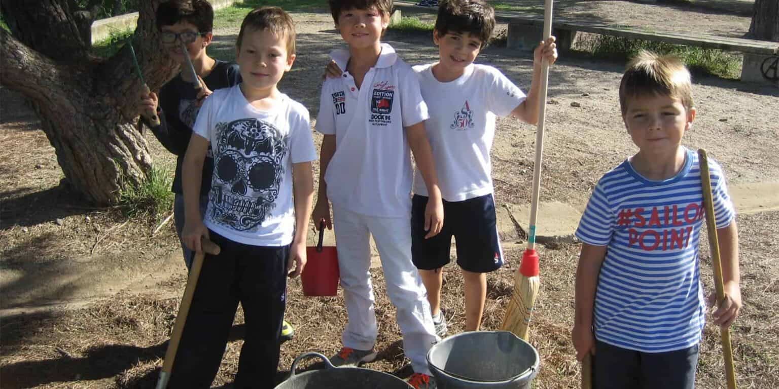 Children planting trees in outdoor school environment for eco education and sustainability.
