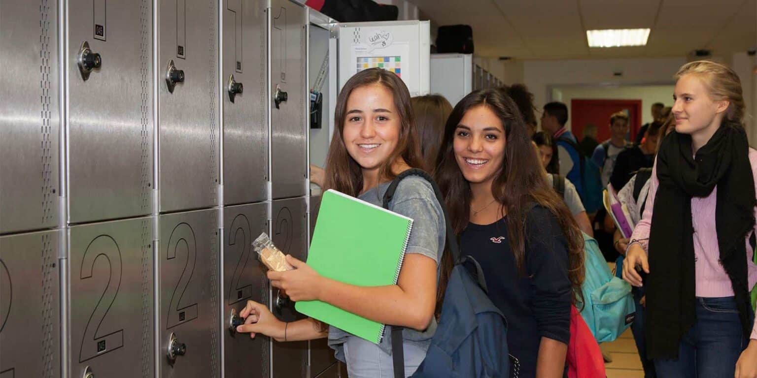 Students using lockers at a world school, promoting safe and organized learning environments.