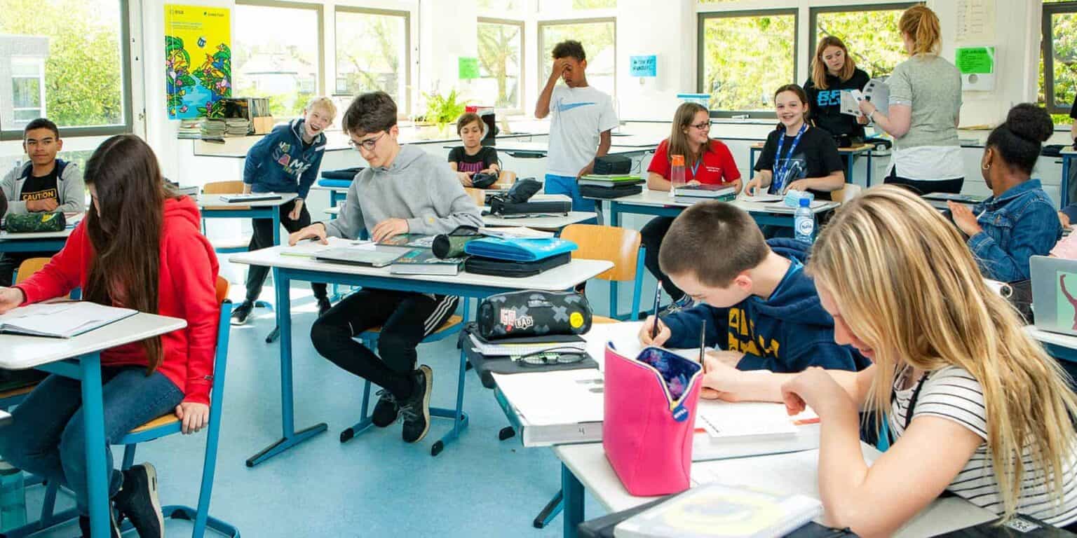 Bright classroom at a world schools international learning environment with diverse students engaged in activities.