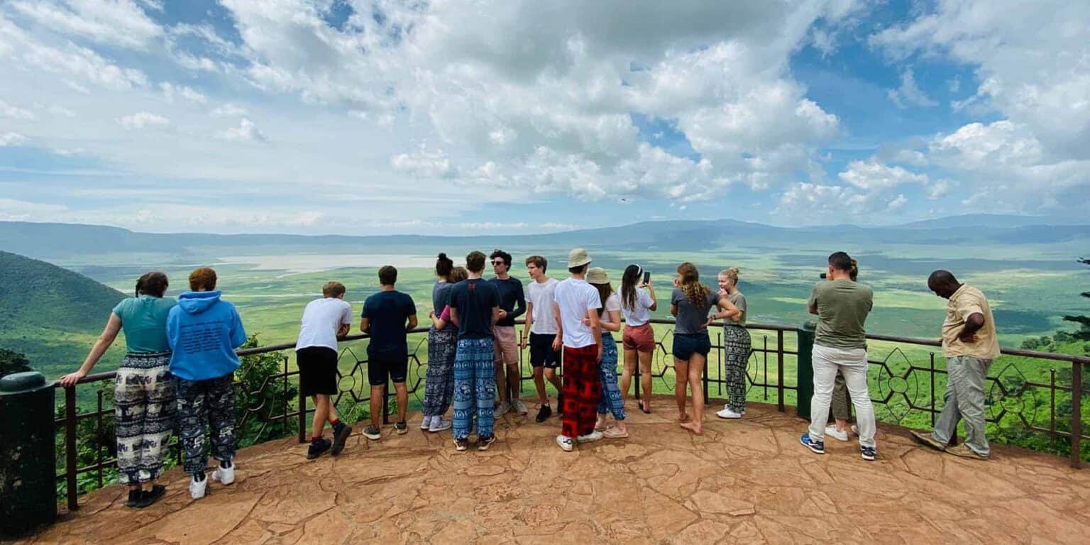 Breathtaking view from a scenic overlook of a lush green valley with students enjoying nature tours.