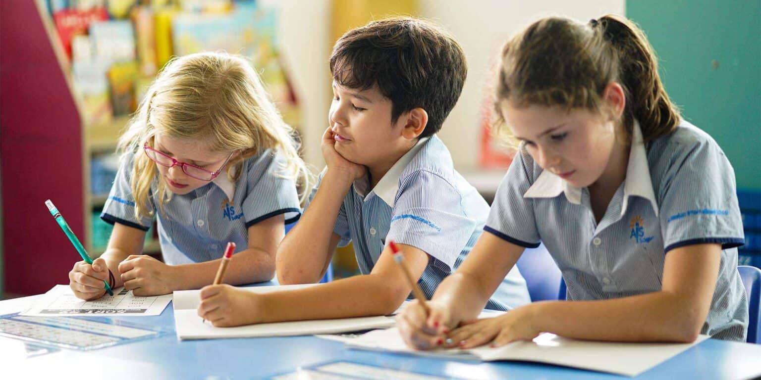 Focused students studying in a classroom, engaging in academic activities at World Schools.