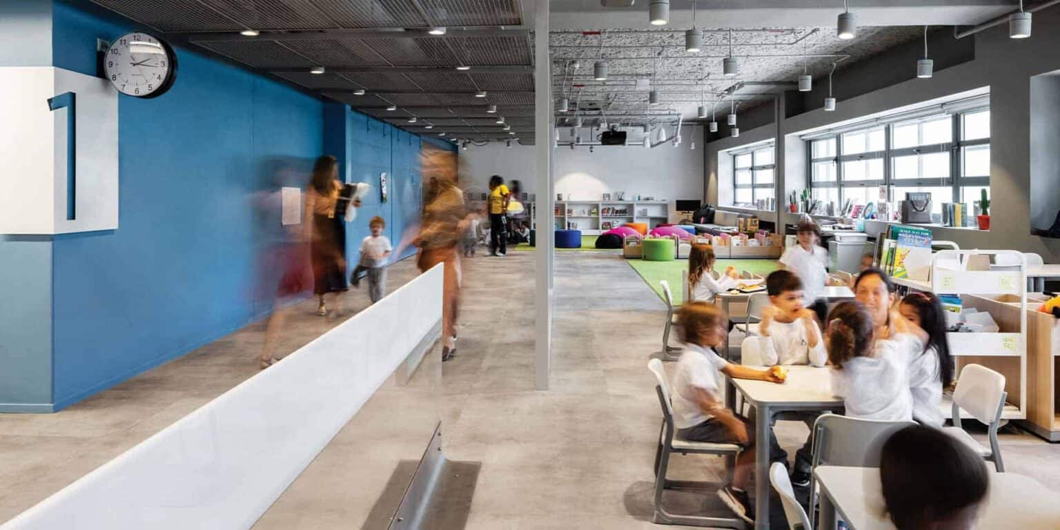 Bright, modern classroom at a world school with children engaging in activities and learning.