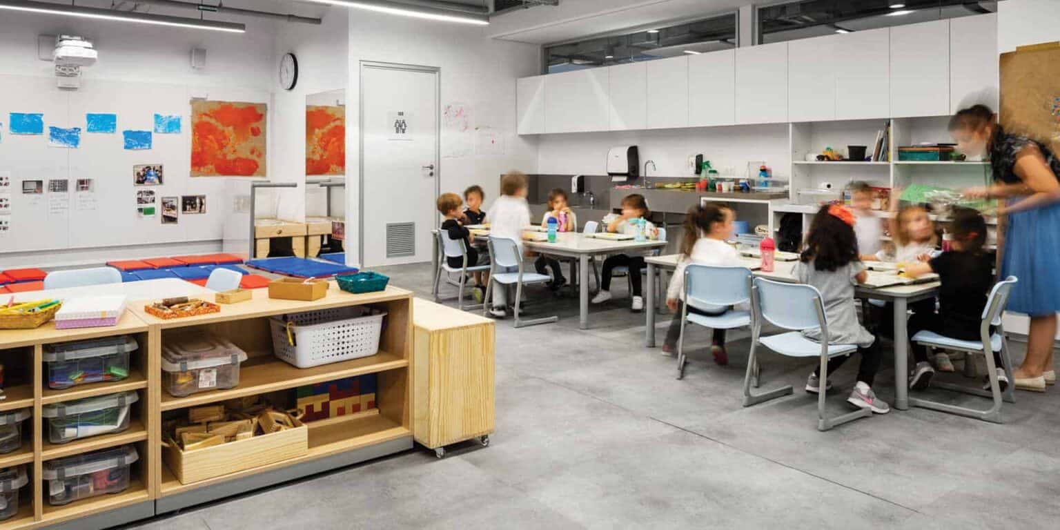 Creative classroom scene with young children engaged in activities at a modern international school.