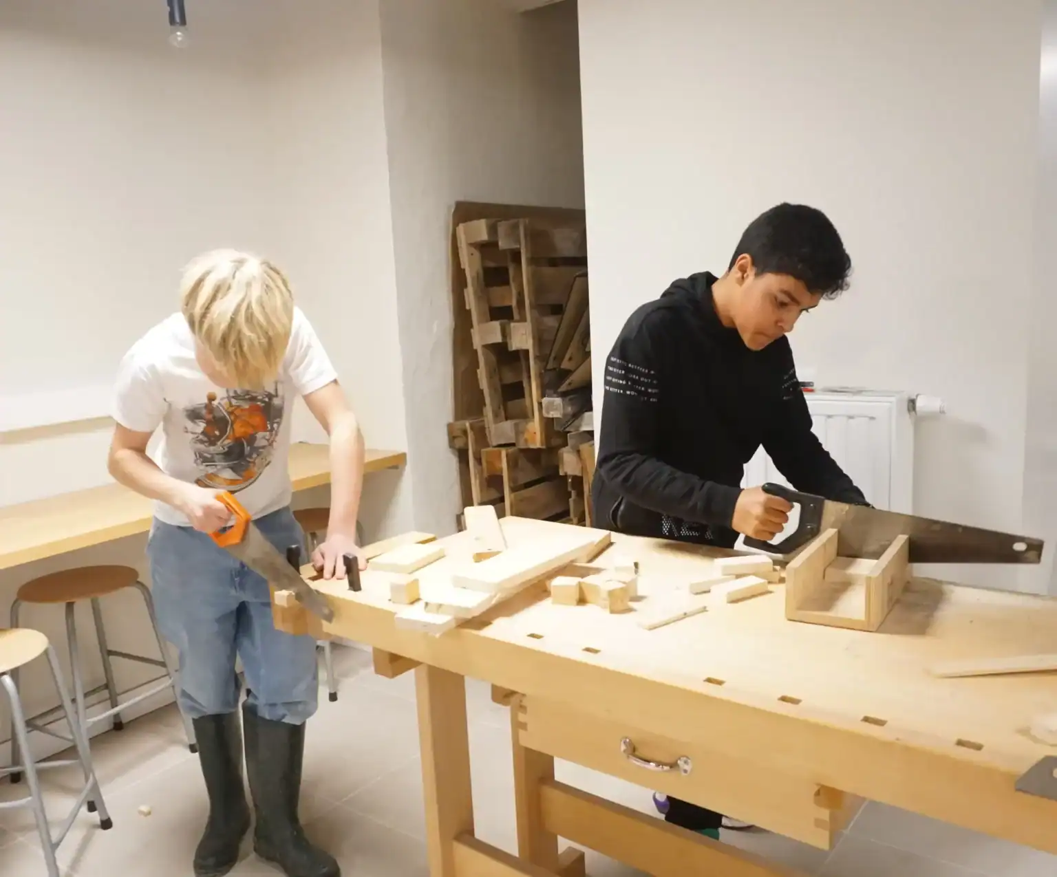 1. Children working on woodworking projects in a classroom at a prominent international school.