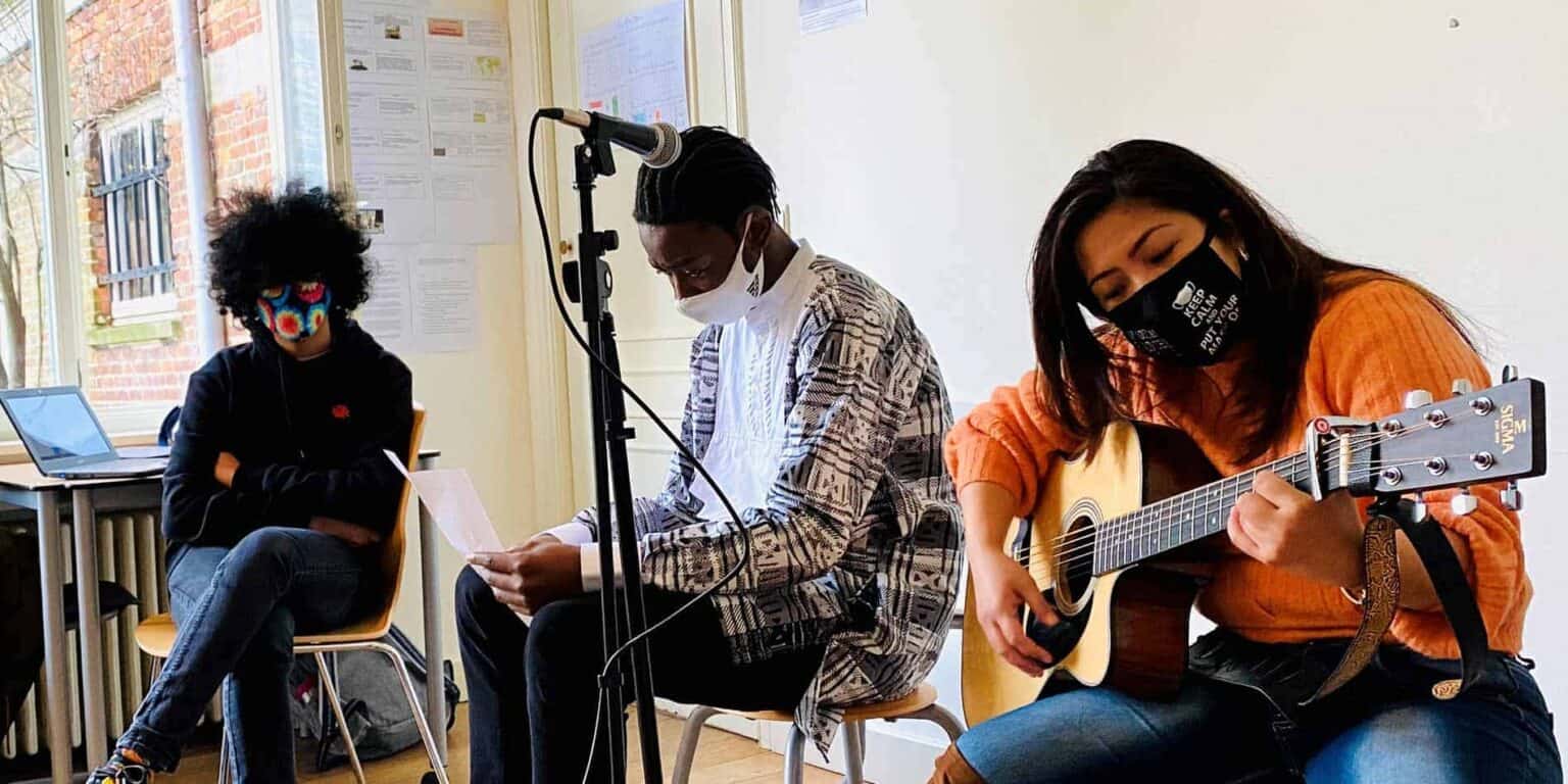 Children participating in a music class at a World Schools program, showcasing diversity and engagement in arts education.