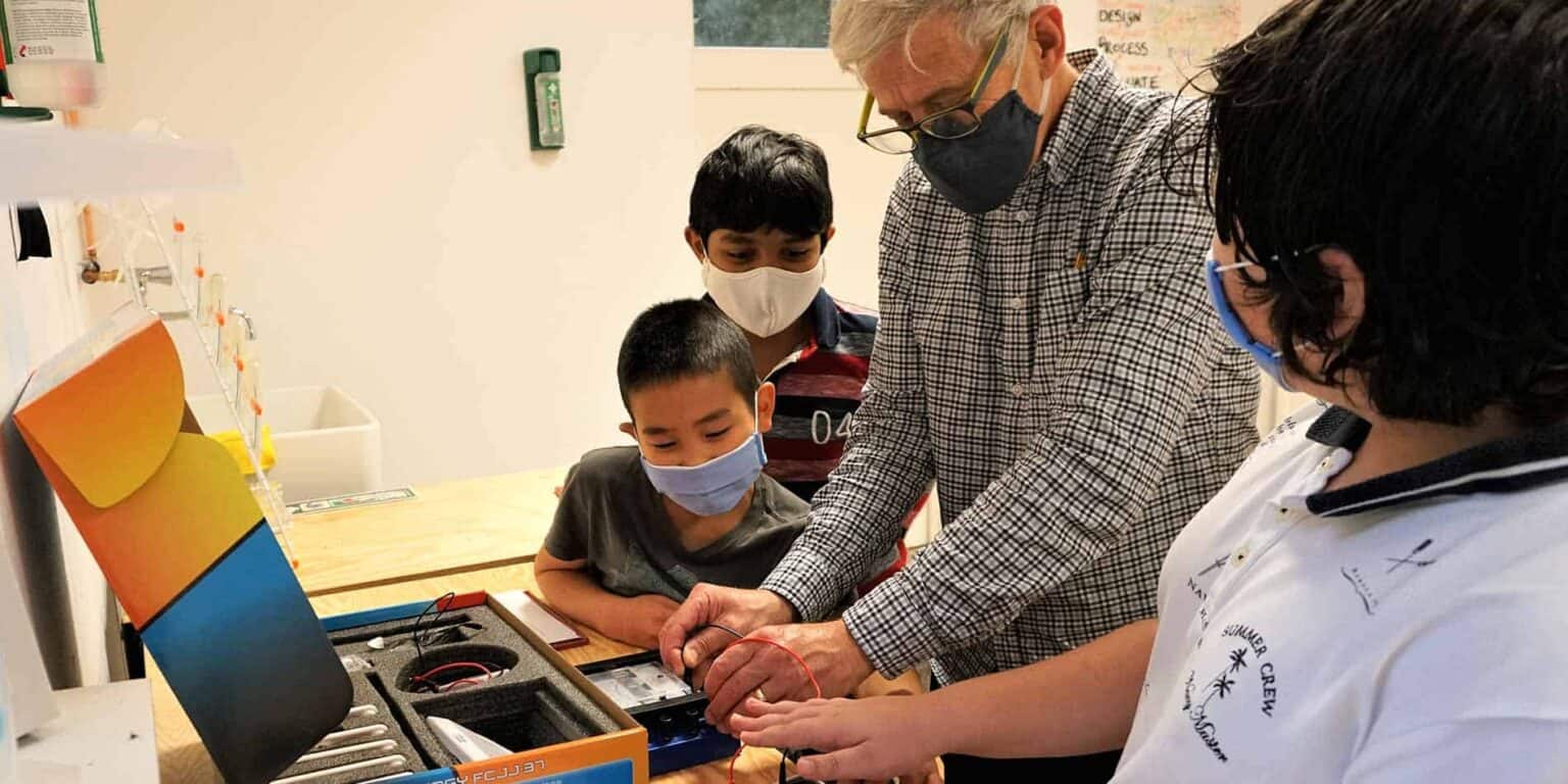 Innovative STEM learning at World Schools with students and teachers engaged in a hands-on science activity.