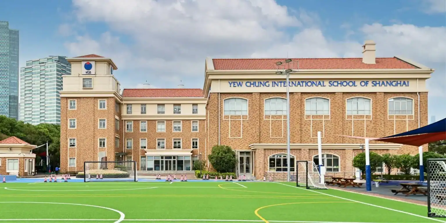 Modern international school building in Shanghai with sports facilities and sports field.