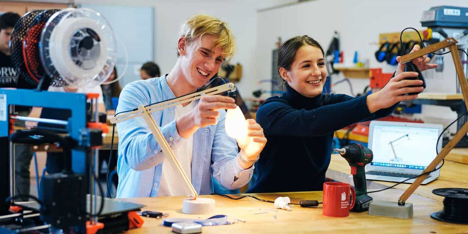 Students engaged in STEM activities at a modern school workshop.