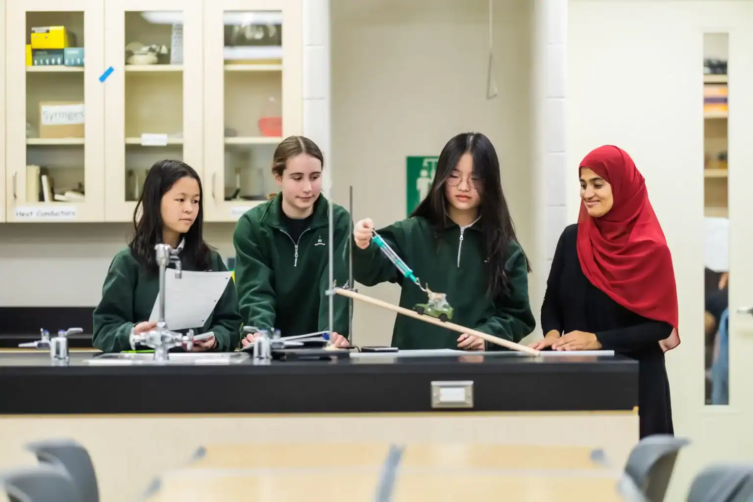1. Students conducting science experiment in a classroom at a world school.