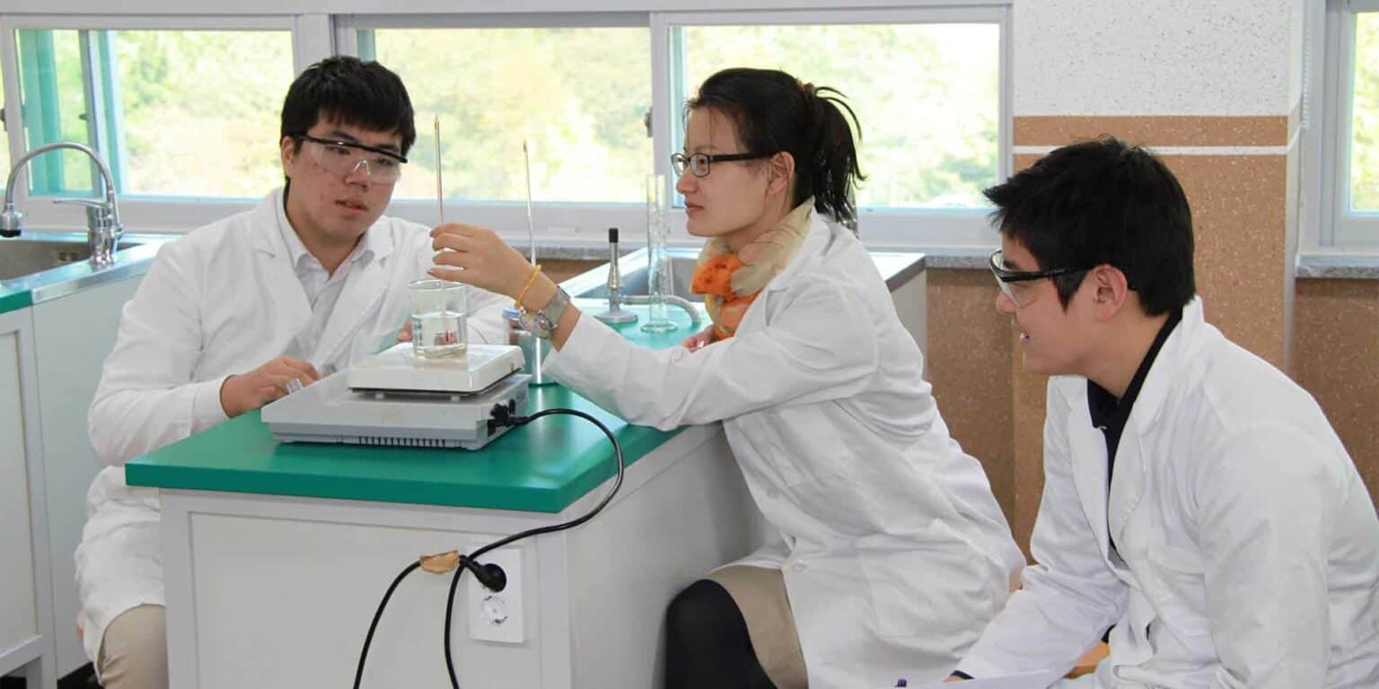 Science laboratory students conducting experiments in a classroom environment.