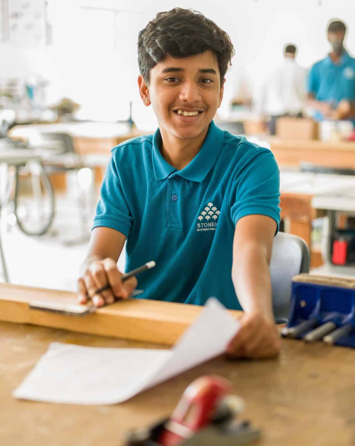 Bright young student at an international school engaging in learning activities for global education excellence.