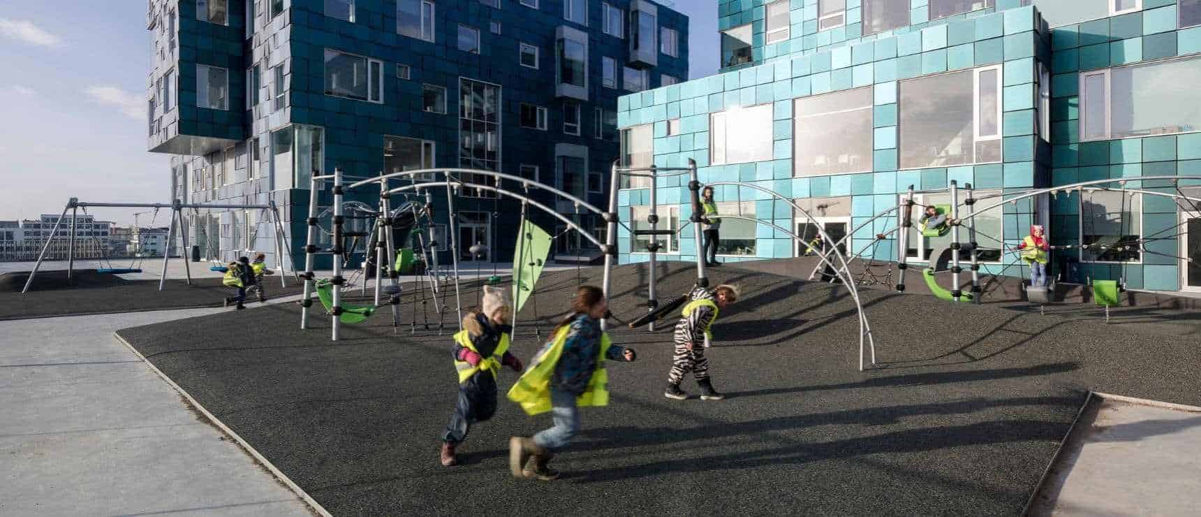 Copenhagen International School Kicks Off 61st School Year with Diverse Global Community 7 Bright modern school building with a vibrant outdoor playground and children playing actively.