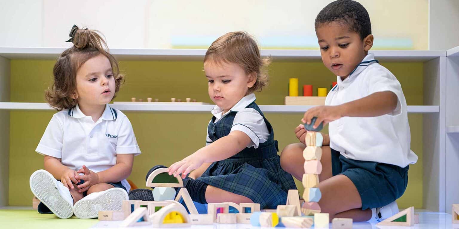 Colorful Montessori classroom with young children playing with educational wooden blocks, fostering early learning and cognitive development.