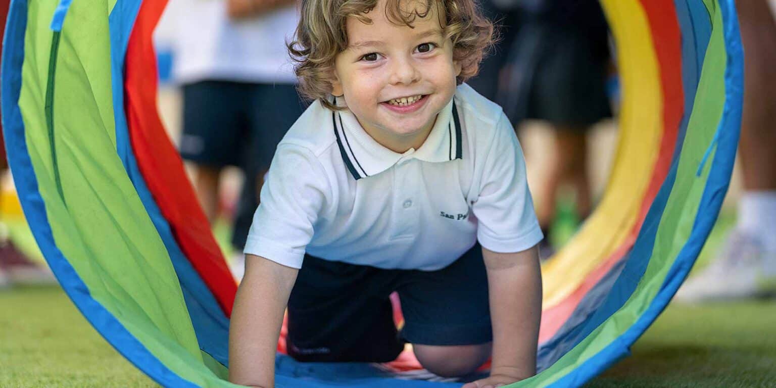 Colorful play tunnel at a modern international school, promoting active learning for young students.