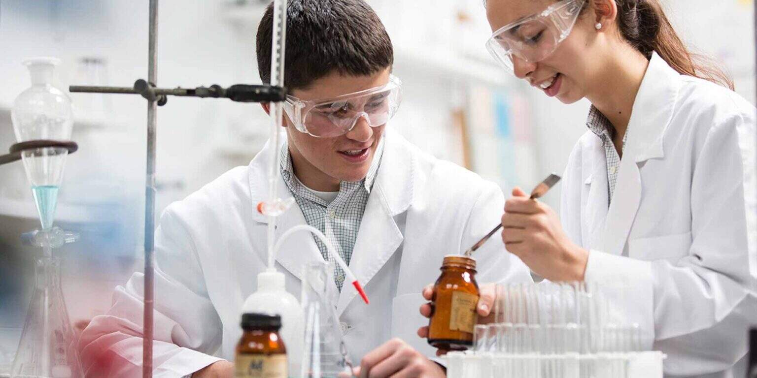 Children engaging in scientific experiments at a school laboratory for STEM education.