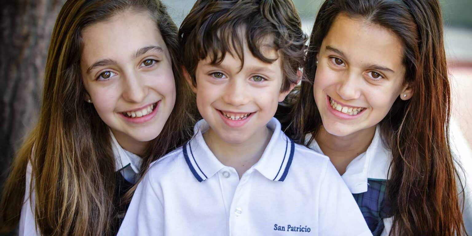 Smiling schoolchildren in uniform outdoors, representing global education and World Schools.