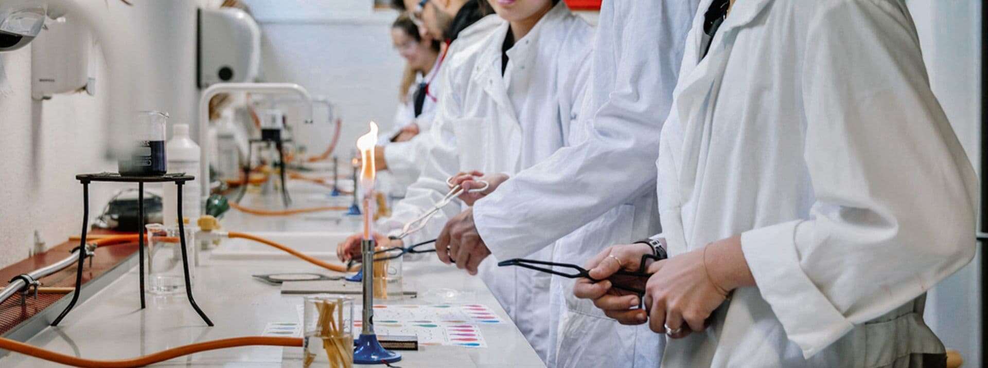 Students conducting scientific experiments in a school laboratory, promoting STEM education and research skills.