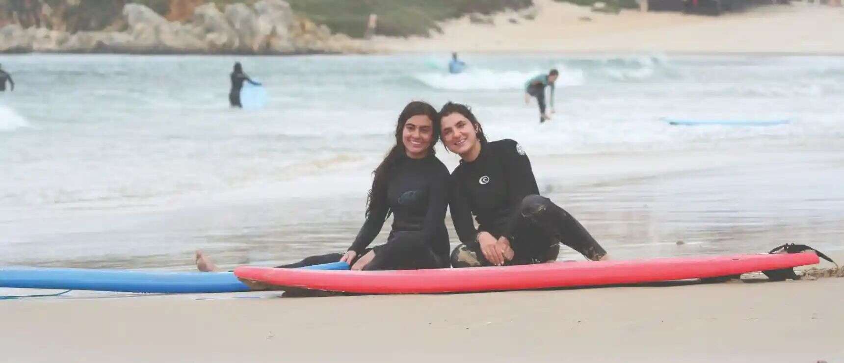 Fun surfers on the beach enjoying water sports and surfing lessons at World Schools.