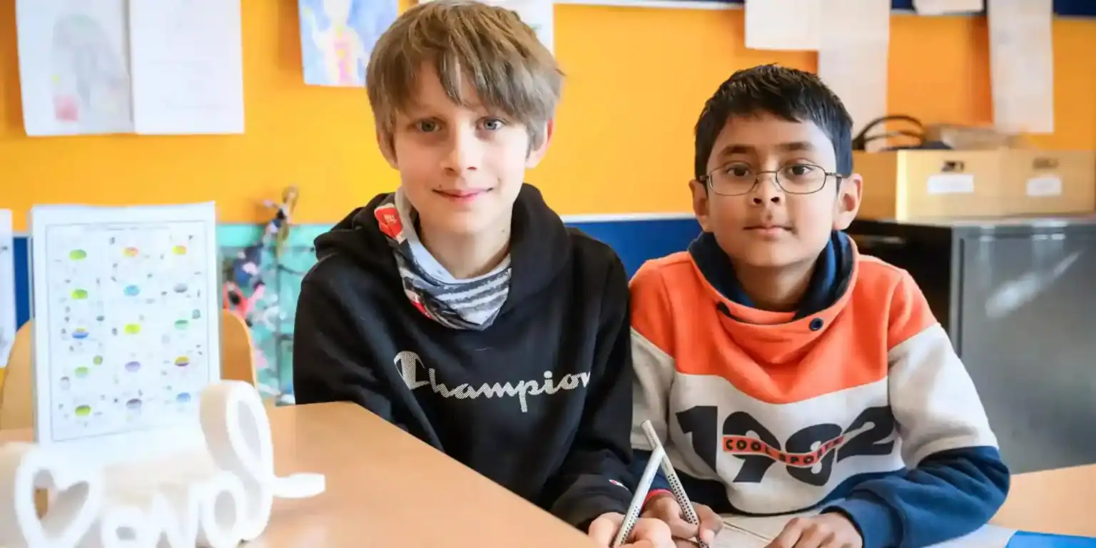 Bright young students in a vibrant classroom at a prestigious international school, fostering global learning and academic excellence.