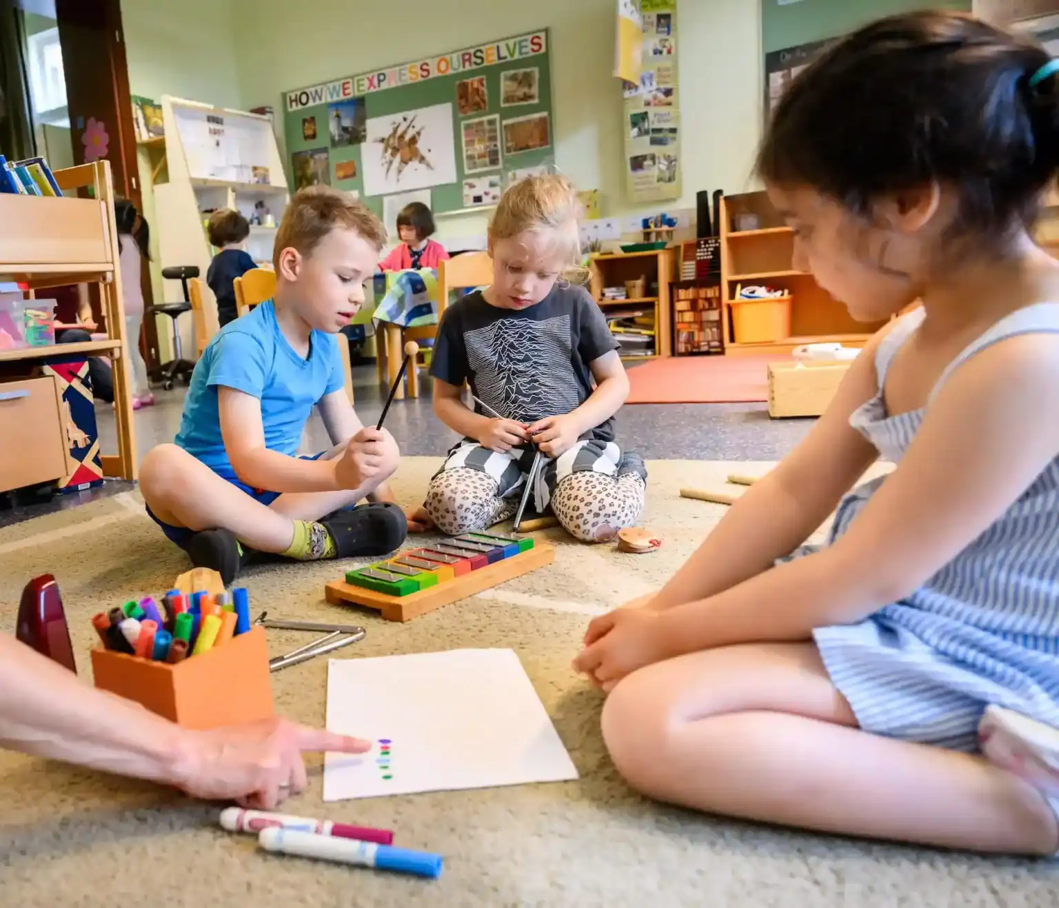 Bright classroom with young children engaging in creative learning activities at World Schools.