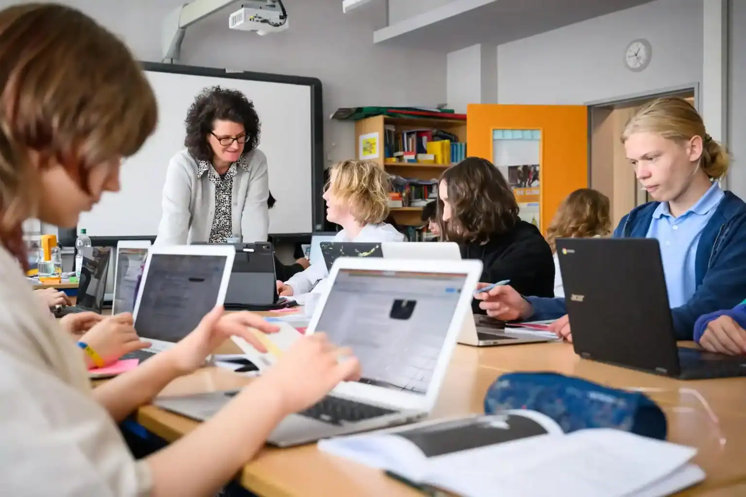 Students engaging in technology-based learning at a world school classroom.