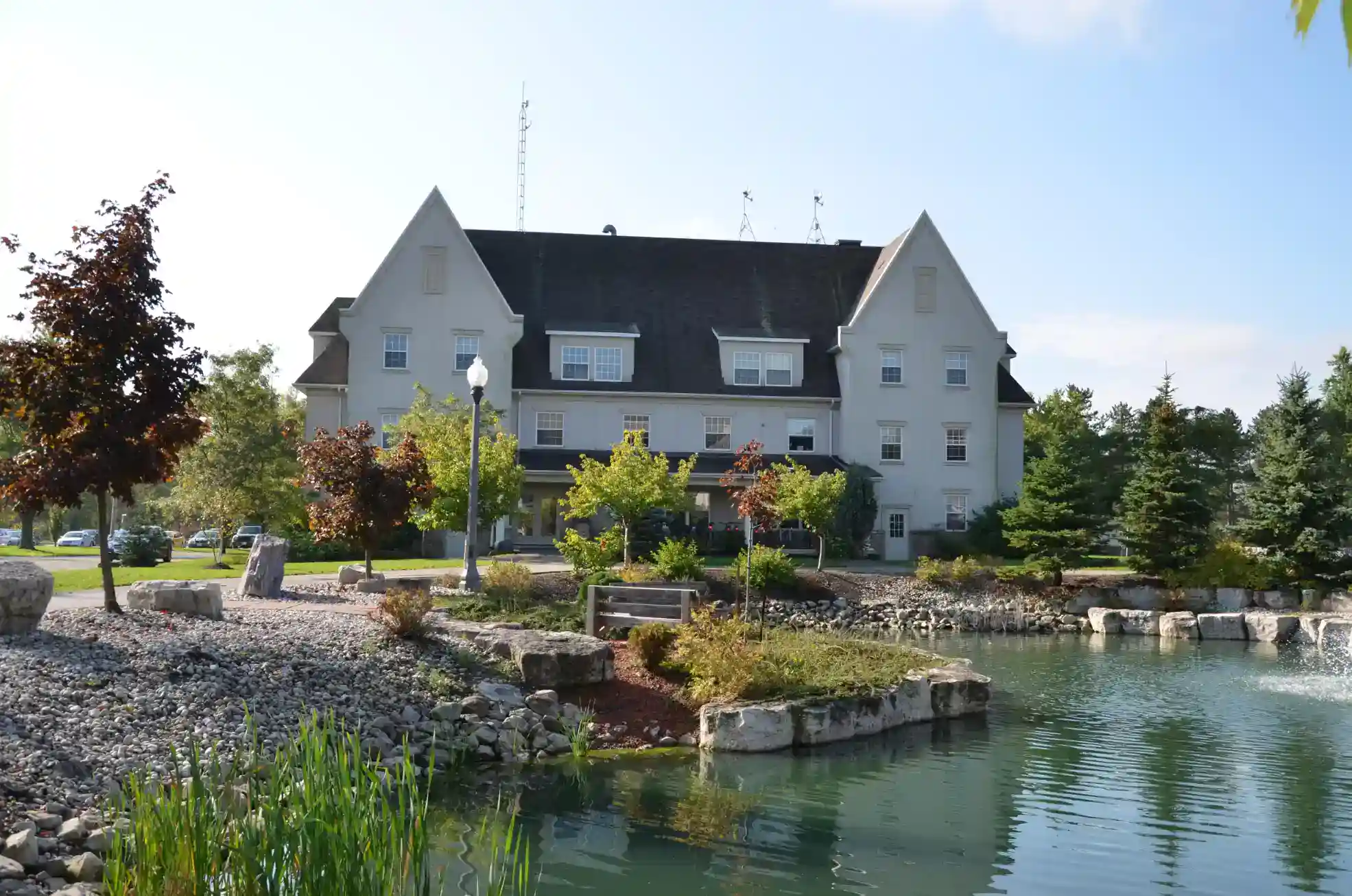 Beautiful campus of a world-renowned international school surrounded by a pond and lush greenery.