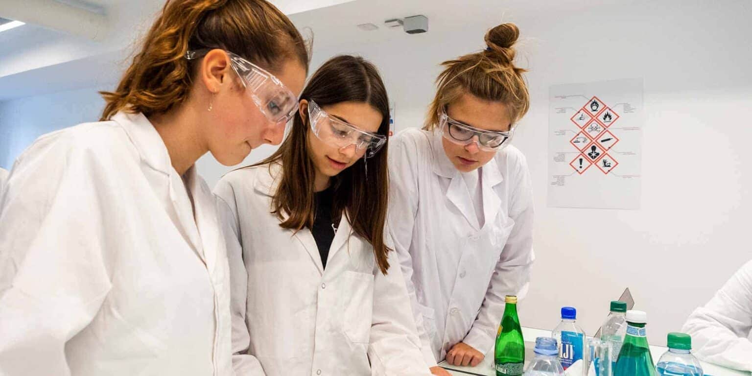 Students conducting a science experiment in a well-equipped laboratory at a world-class international school.