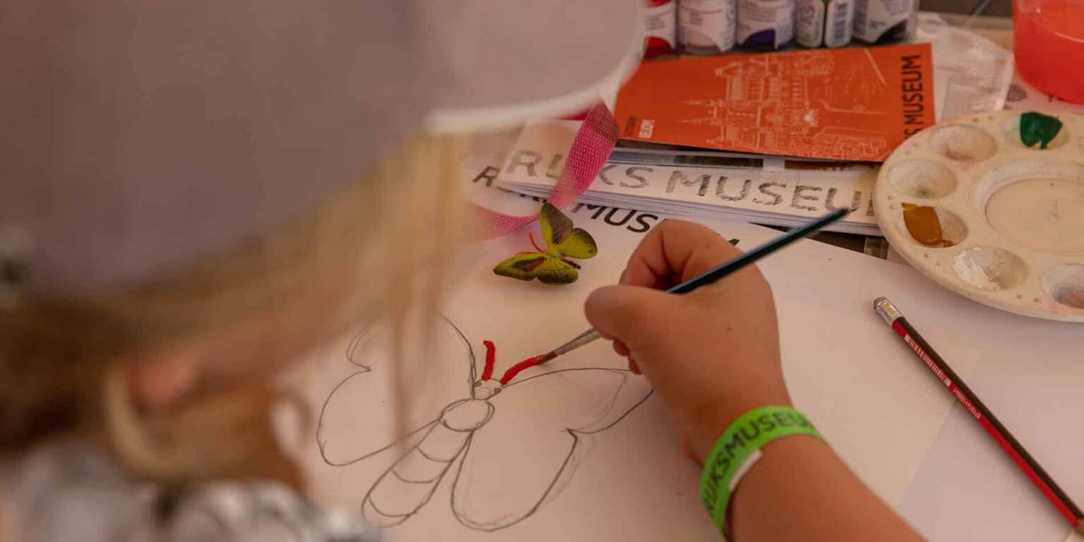 Colorful butterfly sketch being painted at an art workshop for students at World Schools.