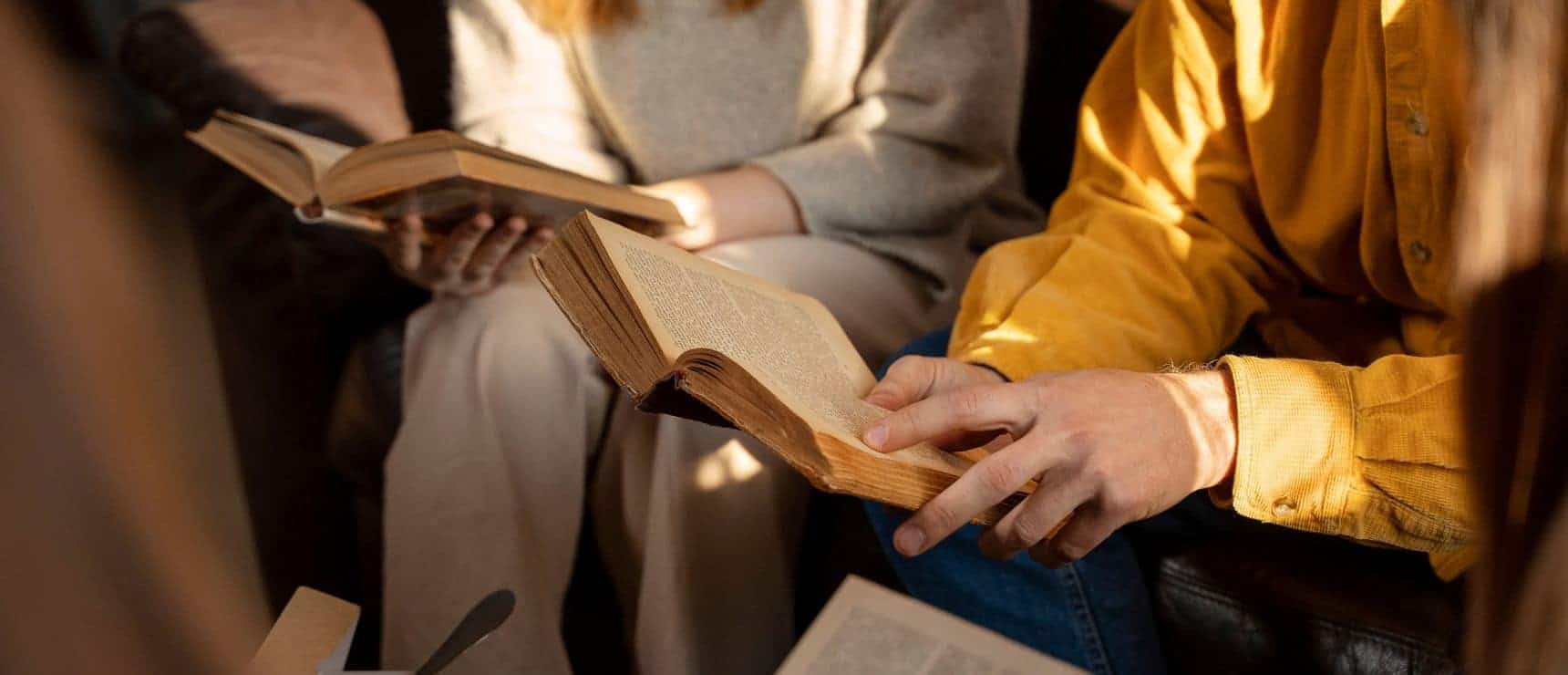 Open books held by students at a world schools event practicing literacy and learning skills.