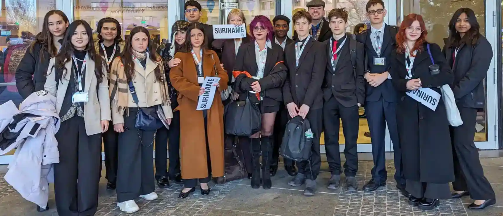 Diverse group of students and teachers at an international school event, promoting global education excellence.
