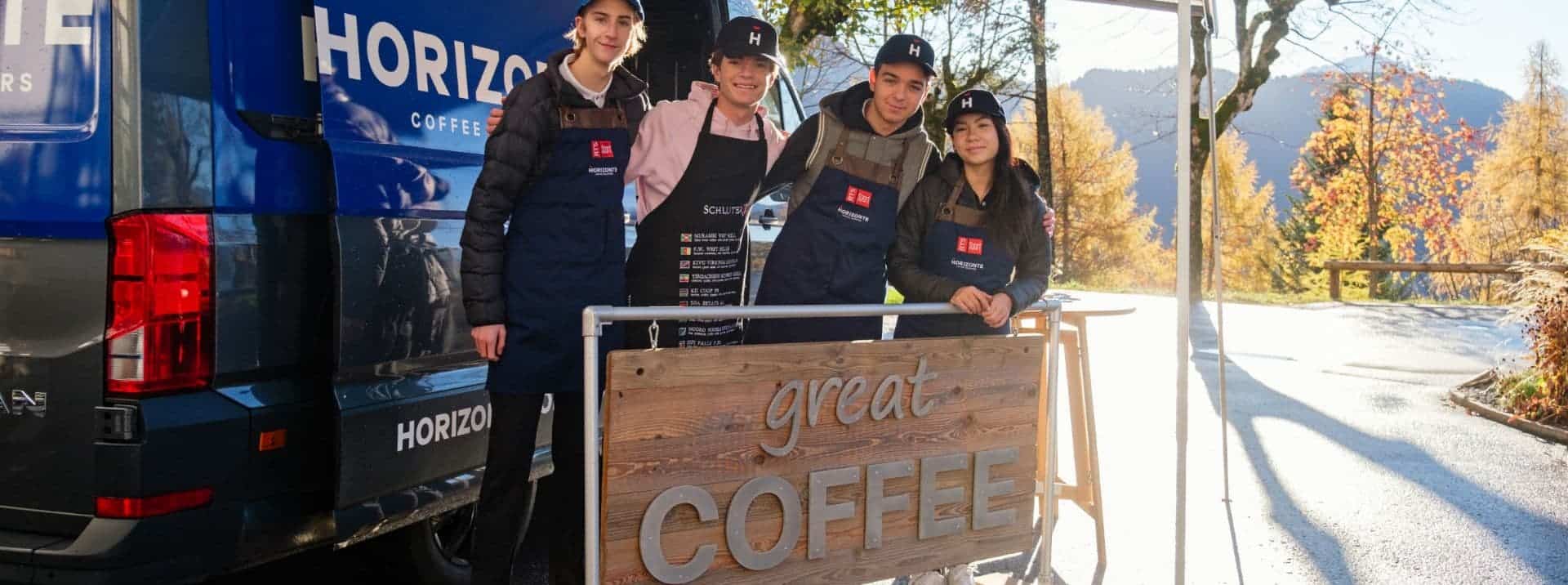 Young students working at a coffee stand outdoors during autumn, showcasing leadership and entrepreneurship skills.
