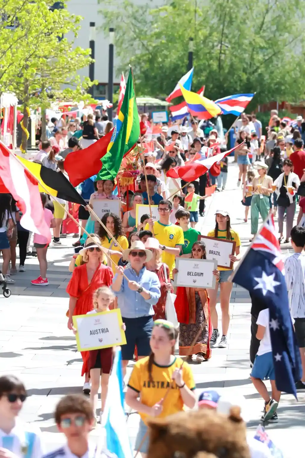 Bright international students parade with flags at a global school event, showcasing cultural diversity and international education excellence.
