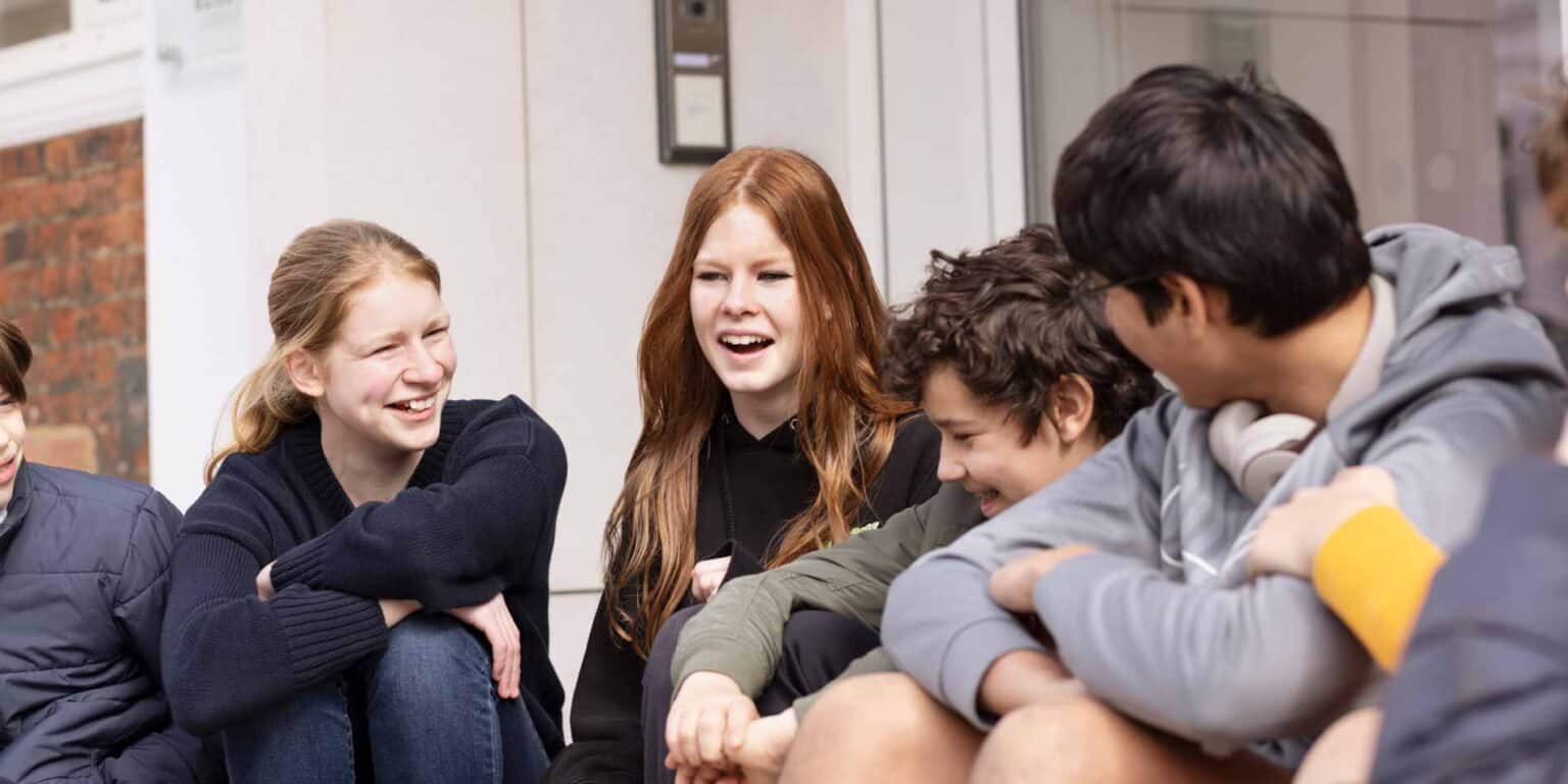 Engaged students chatting outdoors at World Schools, fostering global education and cultural exchange.