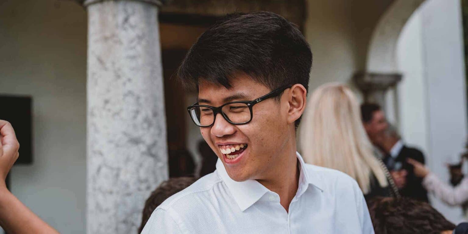 Young student smiling at a school event, representing diverse international education.
